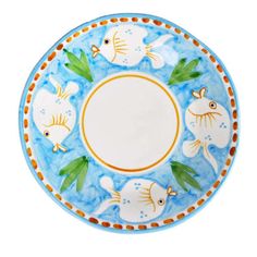 a blue and white plate with fish on it's rim, in the shape of a circle