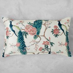 a decorative pillow with peacocks and flowers on it