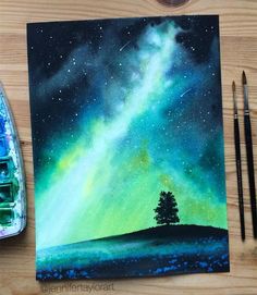 a painting of a tree on top of a hill under the night sky with green and blue lights