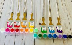 there are many different colors of paint in the bottles and on the spoons with tags that say i love you