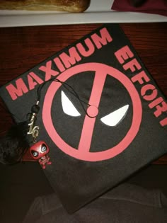 a black and red graduation cap with the word mmmm before it's written