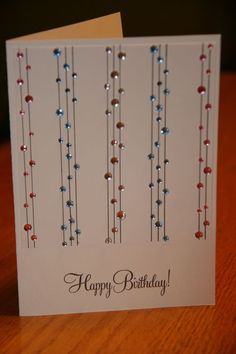 a happy birthday card with beads on it