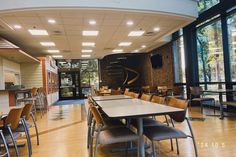 an empty dining room with tables and chairs