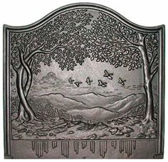 a metal plaque with trees and mountains in the background, on a white background is an image