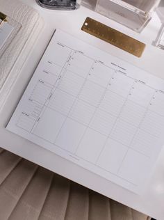 a desk with a planner and pen on it