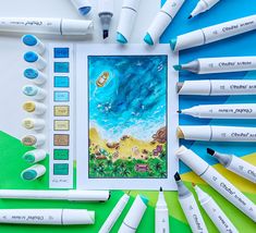 a group of markers and pens sitting on top of a table