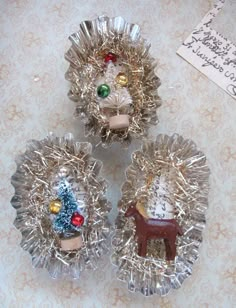 three glass dishes with christmas decorations on them