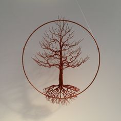 a wire sculpture with a tree inside of it