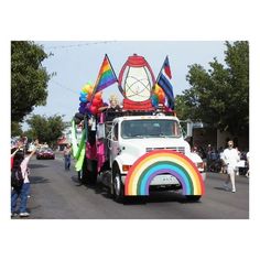 a parade float with people walking on the street