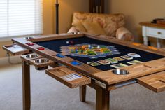 a game table in the middle of a living room with several pieces on it, including dices and cards