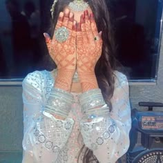 a woman with her hands covering her face