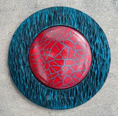 a red and blue plate sitting on top of cement