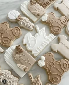 decorated cookies are arranged in the shape of baby's first year names and teddy bears