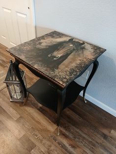 a small table with a horse on it next to a door and a lantern in the corner