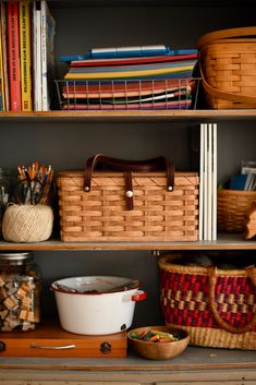 baskets, books and other items are sitting on the shelves