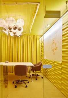 an office with yellow curtains and chairs in front of a whiteboard on the wall