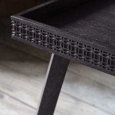 a close up of a wooden table with holes in the top and bottom part on it