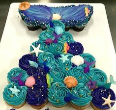 cupcakes decorated with blue frosting and sea creatures