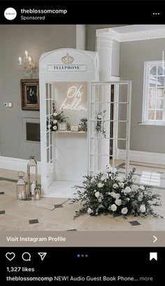 a white display case with flowers in it