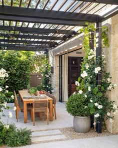 an outdoor dining area with table and chairs