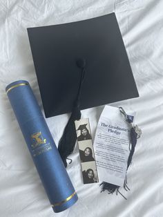 graduation cap, diploma and other items laid out on a bed