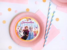 a pink paper plate with an image of frozen princess on it and two straws next to it