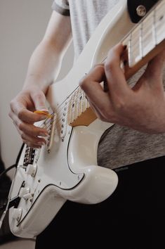 a man is playing an electric guitar