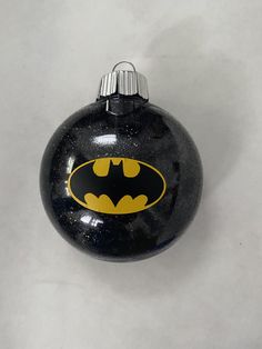 a black ornament with a batman symbol on it