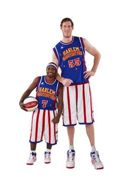 two basketball players pose for a photo in their patriotic outfits, one holding a ball and the other wearing an american flag jersey