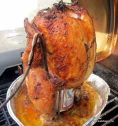 a roasted chicken is sitting on top of the grill