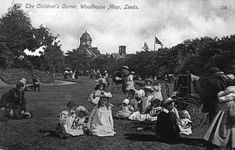 an old black and white photo of people sitting on the grass