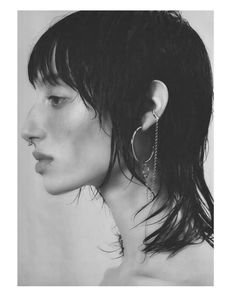 a black and white photo of a woman's head with hair in the wind