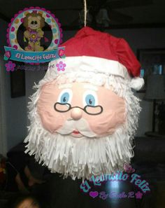 a santa claus ornament hanging from a ceiling