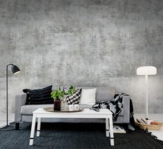 a living room with a couch, coffee table and large world map on the wall