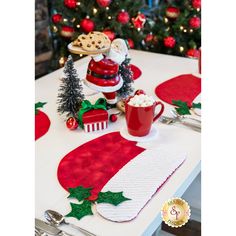 the table is decorated with red and white christmas decorations