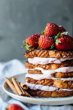 a stack of french toast with strawberries on top