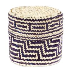 a large woven basket with geometric designs on the top and bottom, sitting on a white surface