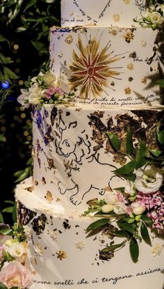 a three tiered wedding cake decorated with flowers