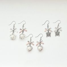 Cute and dainty silver bow earrings, perfect for sprucing up any outfit! Comes in 3 variations, perfect for anyone! -made with heavy duty jump rings!! -handle with care! items are made to prevent any damage but they are still handmade so handle gently!  -all items are personally tested to ensure best quality -all orders come with freebies! Cute Silver Earrings With Bow, Dainty Silver Bow Earrings, Silver Dangle Earrings With Bow, Silver Metal Earrings With Bow, Dainty Silver Earrings, Glow Stars, Silver Bow, Bow Earrings, Pretty Jewellery