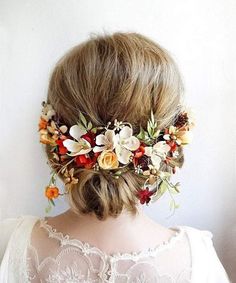 a woman with flowers in her hair wearing a white dress and a flower crown on her head