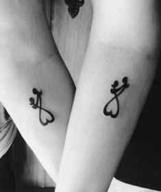 two people with matching tattoos on their arms