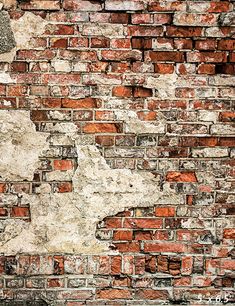 an old brick wall with peeling paint on it