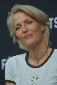 a woman with blonde hair wearing a white shirt