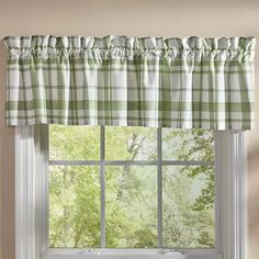 a window with a green and white checkered valance hanging from it's side