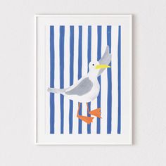 a white bird standing on top of a blue and white striped wall next to a wooden frame