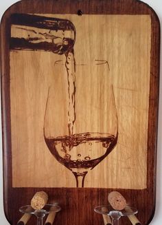 a wooden plaque with wine glasses and corks on it