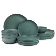 a set of green dinnerware on a white background