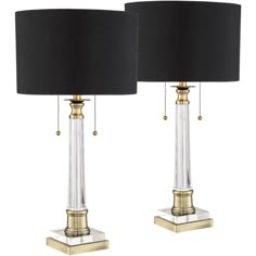 a pair of lamps with black shades on them