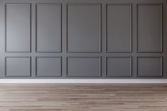 an empty room with gray walls and wooden floors is shown in this image, there are no people or objects on the wall