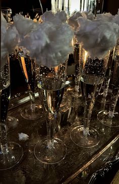 several champagne glasses filled with bubbles on a table